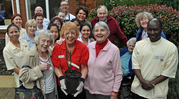 Sylvie Craig-Swainson, Activity Organiser, prepares to plant the rose marking Dignity Action Day