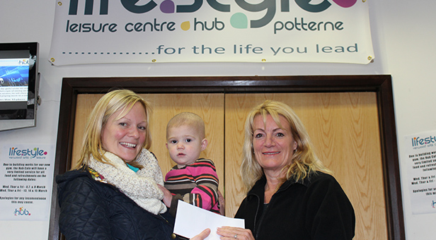 Denise presenting a cheque to Judith and Josie