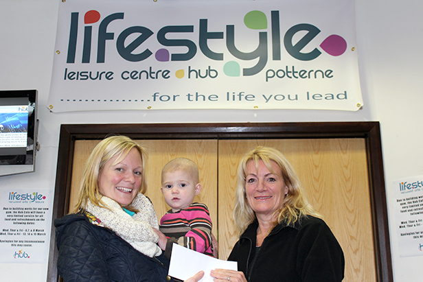 Denise presenting a cheque to Judith and Josie