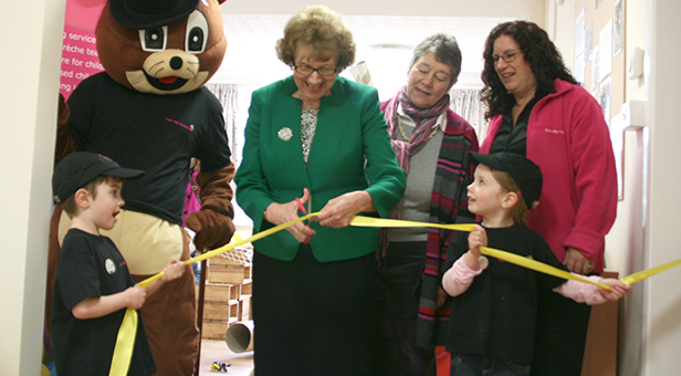 Annette Brooke cuts the ribbon with the Tops mascot and Cheryl Hadland, Managing Director of Hadland Care Group