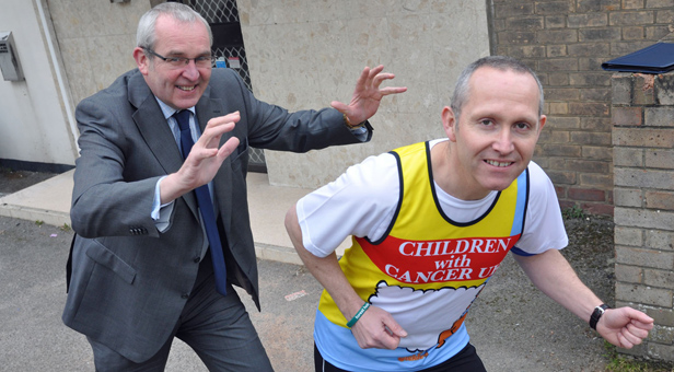 Nigel Smith, Ellis Jones' Managing Partner (left) provides a helpful push to solicitor Craig Wells as he prepares for the London Marathon