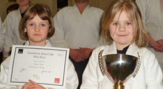 Mini Jitsu Students Seren presented with her promotion certificate