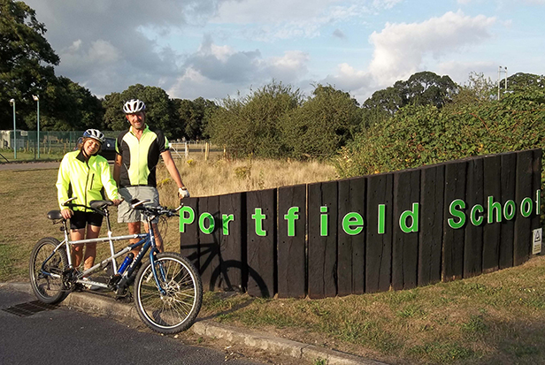 Nikki Budd and her partner Mark Morley on their tandem bike outside Autism Wessex’s Portfield School, next to the finish location in Christchurch