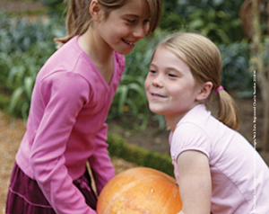 Girls carrying pumpkin