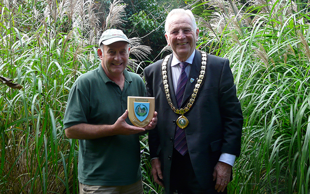 Neil Lucas (left) receiving his plaque from the Mayor of Ferndown