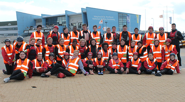 Jaffa Citrus school competition winners celebrate outside Weymouth and Portland National Sailing Academy