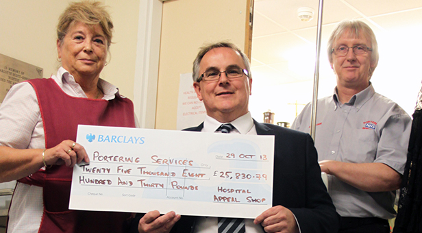 Dorinda Sheppard, Appeal Shop volunteer (left) and RBH Financial Accounts Manager Mike Wilkinson (centre – trying one of the new wheelchairs and finding it very comfortable) present Ian Barnett Potts, Porter Services Manager (right) with the new wheelchair funds