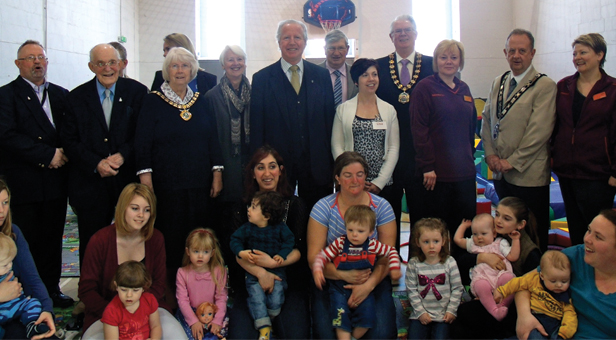 Dignitaries pose with organiser, mums and tots for a photograph