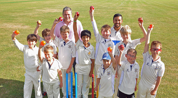 Bowled over: Princecroft Willis Partner James Robinson (back left) and Head Coach Badrul Alam with members of Poole Town Cricket Club's youth section