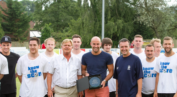 Paul Roast receives a presentation before the start of Saturday’s game against AFC Bournemouth flanked by Chairman Ken Stewart (l) manager Steve Cuss (r) and members of the squad. © Simon Carlton
