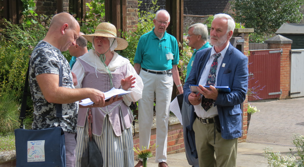 Judges Matt Wakefield (left) and Derrek Donnison-Morgan are shown round the Physic Garden by Denise Colling