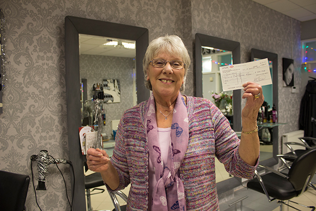 Gwen Moss collecting her cheque at Leanne's Hairdressers in West Moors