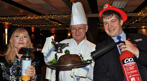 READY TO IGNITE: (left to right) Toyah Willcox puts a flame to the pudding held by head chef Tony Shepard, while guest services manager Andy Thompson holds the fire extinguisher at the ready
