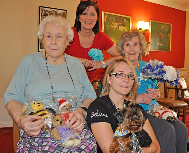 With their handmade teddy bears and paper flowers are resident Irene Brown (left), Activity Organiser Sandra Boulton and resident Betty Elvy at Colten Care's Avon Reach care home in Mudeford, pictured with stroke campaigner Claire Whitehouse