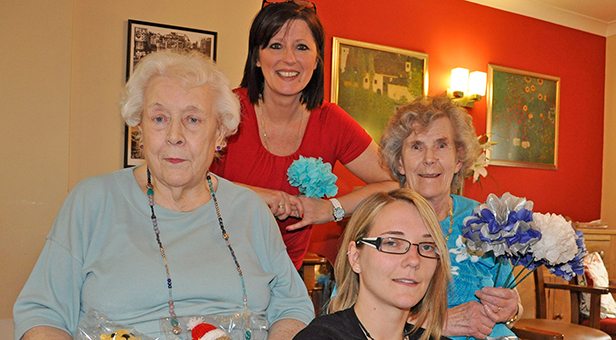 With their handmade teddy bears and paper flowers are resident Irene Brown (left), Activity Organiser Sandra Boulton and resident Betty Elvy at Colten Care's Avon Reach care home in Mudeford, pictured with stroke campaigner Claire Whitehouse