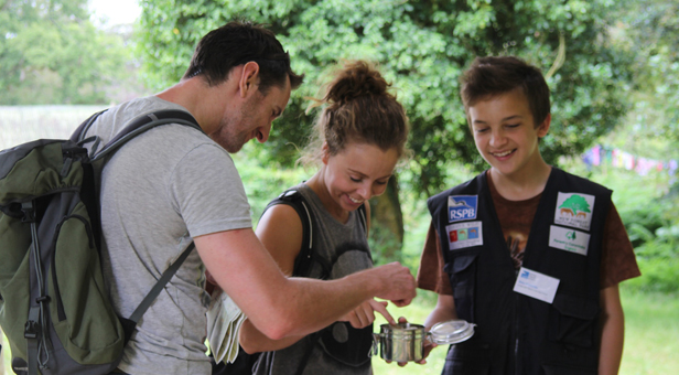 Dominik Reynolds (right) speaking to visitors whilst volunteering at the New Forest Reptile Centre near Lyndhurst