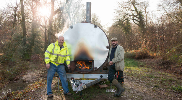 Pondhead Conservation Trust volunteers Derek Tippetts and Dave Dibden stand by the group’s charcoal burner.