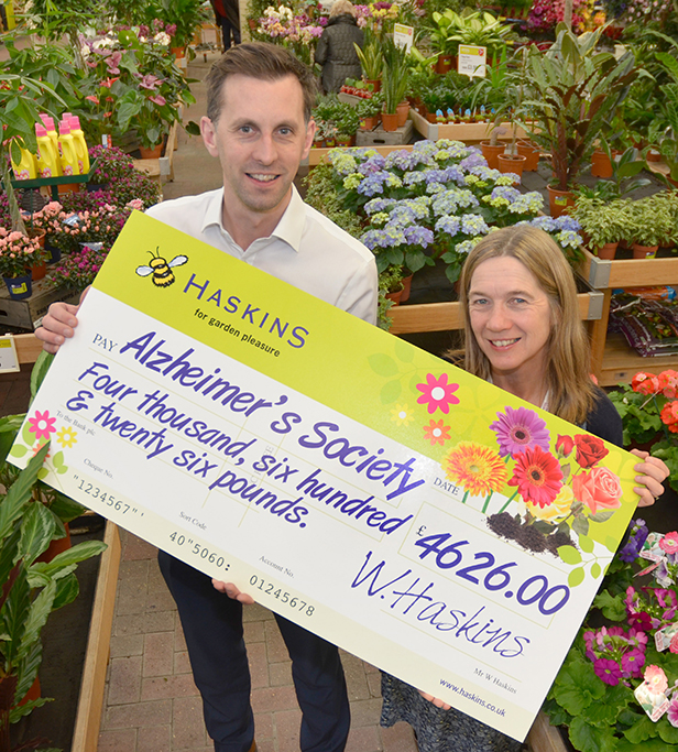 Matt Hill (left) presents the £4626 cheque to Jo Malyon on behalf of customers and staff