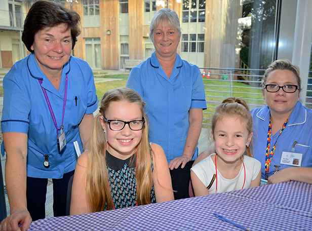 Nikki's daughters Leah & Megan with Lewis-Manning nurses at book launch