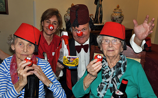 Tommy Cooper impersonator Clive Greenaway marks Comic Relief with Canford Chase Activities Organiser Maria Grant and residents Jean Palmer and Sylvia Sansome