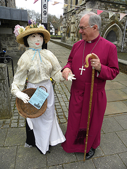 The Bishop of Sherborne is welcomed to the Coffee Morning by ‘Matilda’, one of the papier  maché figures that will be on show at the flower festival