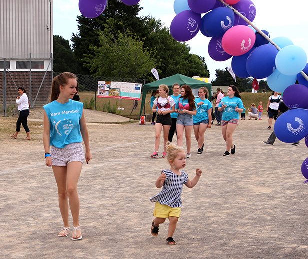 DARCIE OVAL (Aged 2): One of the youngest participants to walk a whole lap, pictured here with watchful team member Demi