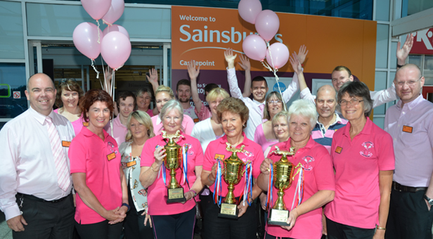 (from left) Paul Barlow and Sainsburys staff, with members of Bournemouth’s Pink Champagne Dragon Boat Team.