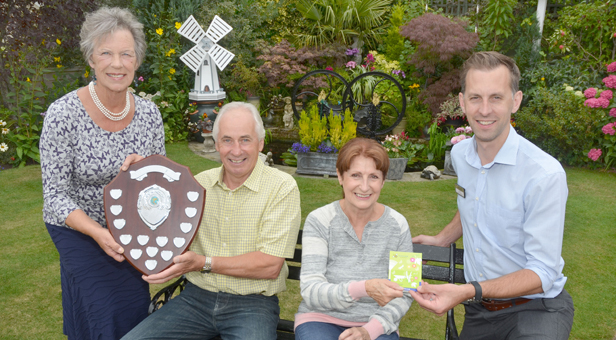 Winners Barrie and Shelia Smith receive the Ferndown In Bloom shield from Jean Read (left) and gift card from Matt Hill (far right)