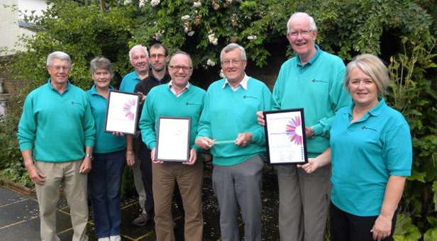 Some members of the Wimborne in Bloom Committee with their awards and Glen Holdsworth, the Town Council groundsman (wearing a black top) responsible for maintaining Redcotts Recreation Ground