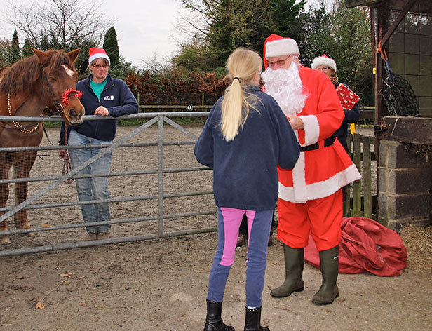 Santa hands out gifts at Green Cottage RDA