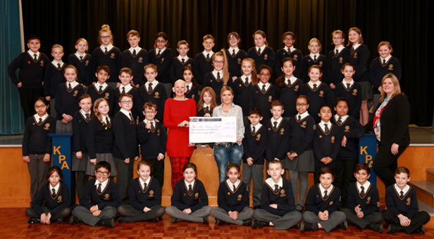 A SCHOOL EFFORT - Year six pupils celebrate Molly's Hair Raising Event - with Sue Hampton (middle in red), Molly Milligan (to her left) and Molly's mum Claire Heaton (holding cheque). Associate principal Dawn Wilks is far right