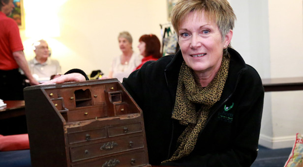 Valuable find: Linda Thornton with her 18th century bureau bookcase used to store her grandmother's buttons and which, in pristine condition, could be worth up to £5,000
