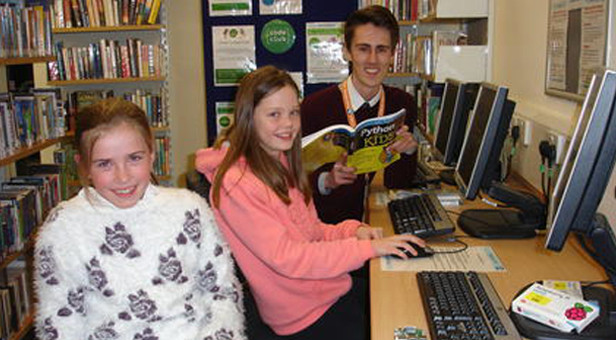 Children and library volunteer ready to start coding