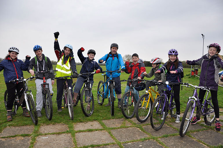 GOING GREEN FOR ECO WEEK: Parent James Hobbs (centre) is joined by pupils in Alderholt ready for their trip