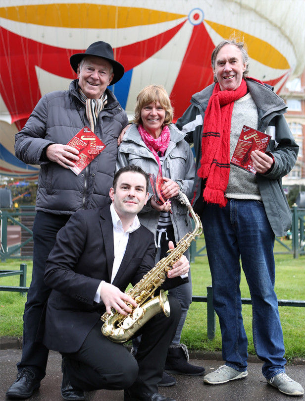 Festival director, Gerry Clarke with festival PA, Sandra Bird and saxophonist Tom Gwyther meet local film producer John Cadd during a break in filming in the town centre recently 