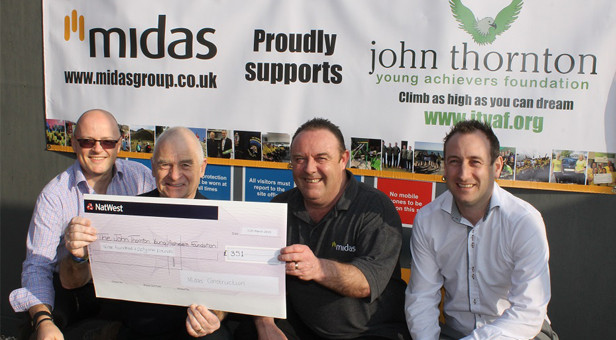 Peter Thornton (second from left) receives a cheque from Midas Construction