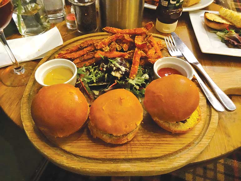 Trio of mini
burgers - beef with bacon and cheese, pork and
apple and minted lamb burgers in brioche buns
with sweet potato fries, mustard and ketchup