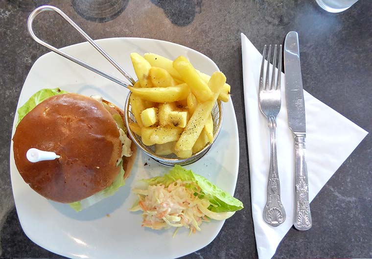 Homemade chargrilled Dudsbury burger in brioche bun with Cheddar cheese and fries