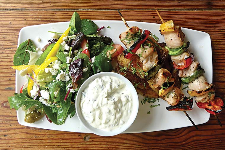 Chicken kebabs with Cajun-fried potatoes, tzatziki and Greek salad