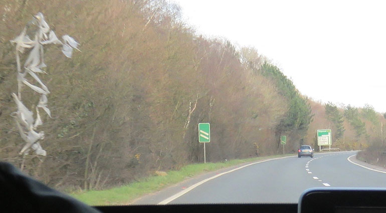 A31 What appears to be commercial litter in trees along Ferndown bypass near West Moors slip road