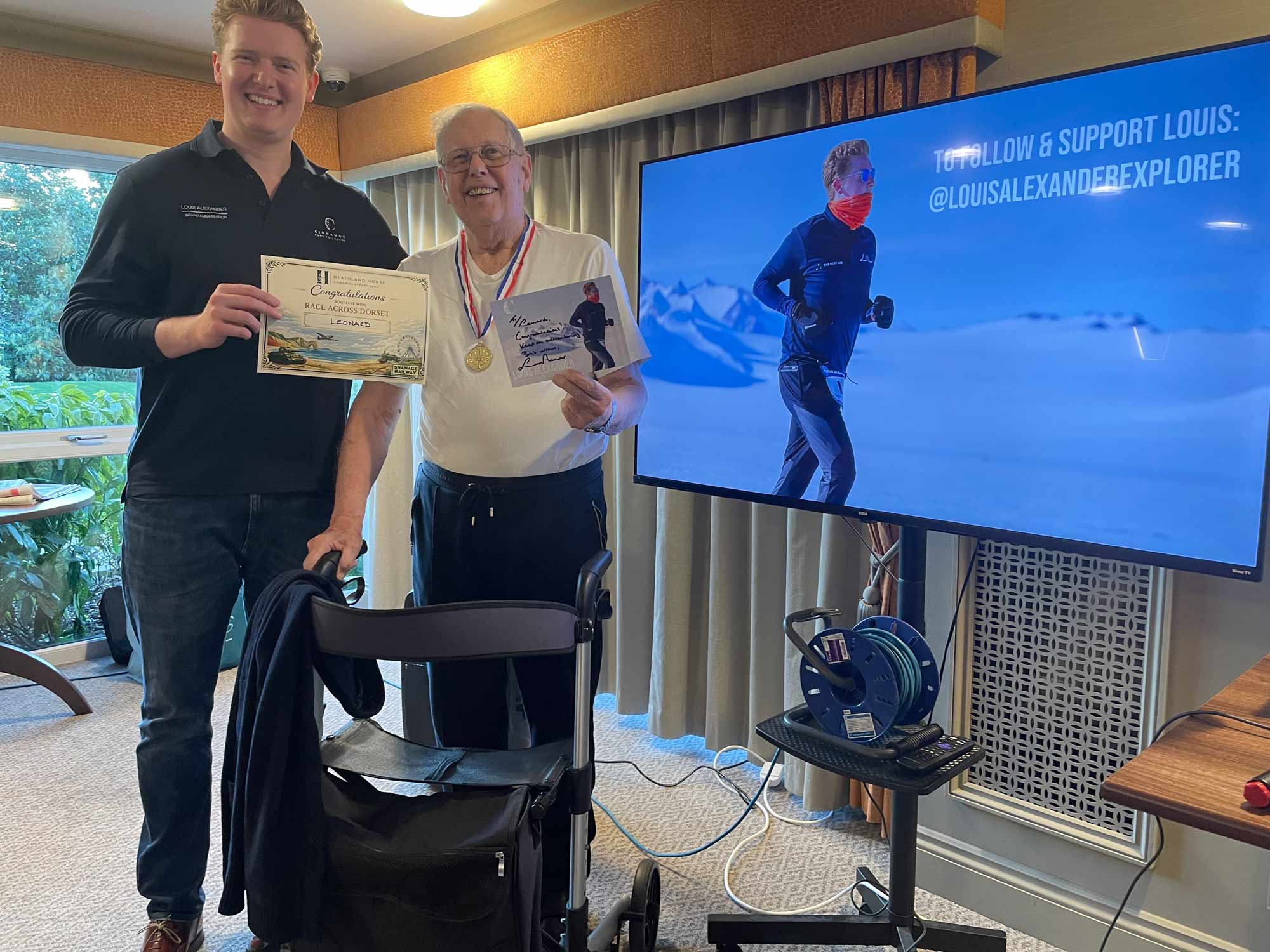 Louis Alexander presented Leonard Symonds with a certificate and medal at Heathland House Care Home © BBPR