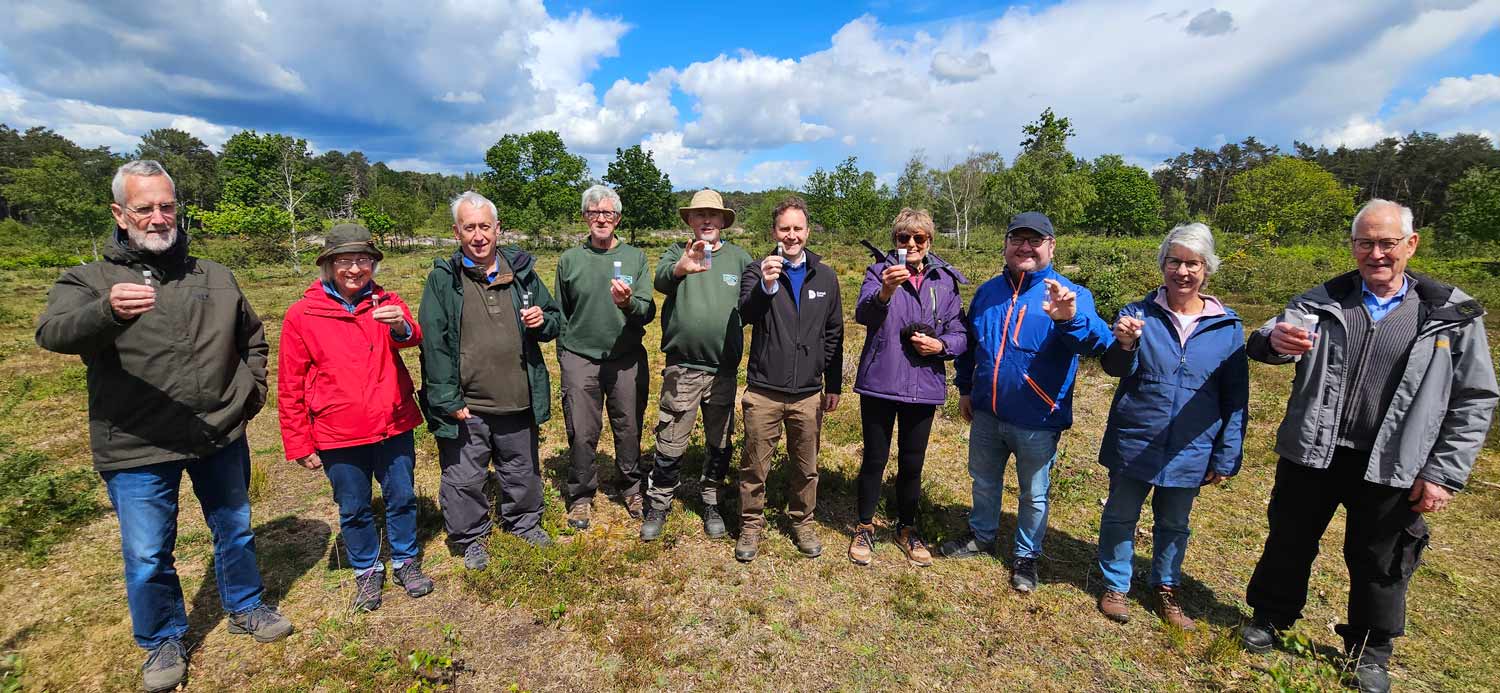 Air quality volunteers with Tim Newman holding sample tubes at Matchams View