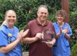 Paul Payne with Forest Holme Hospice nurses receiving his presentation plaque