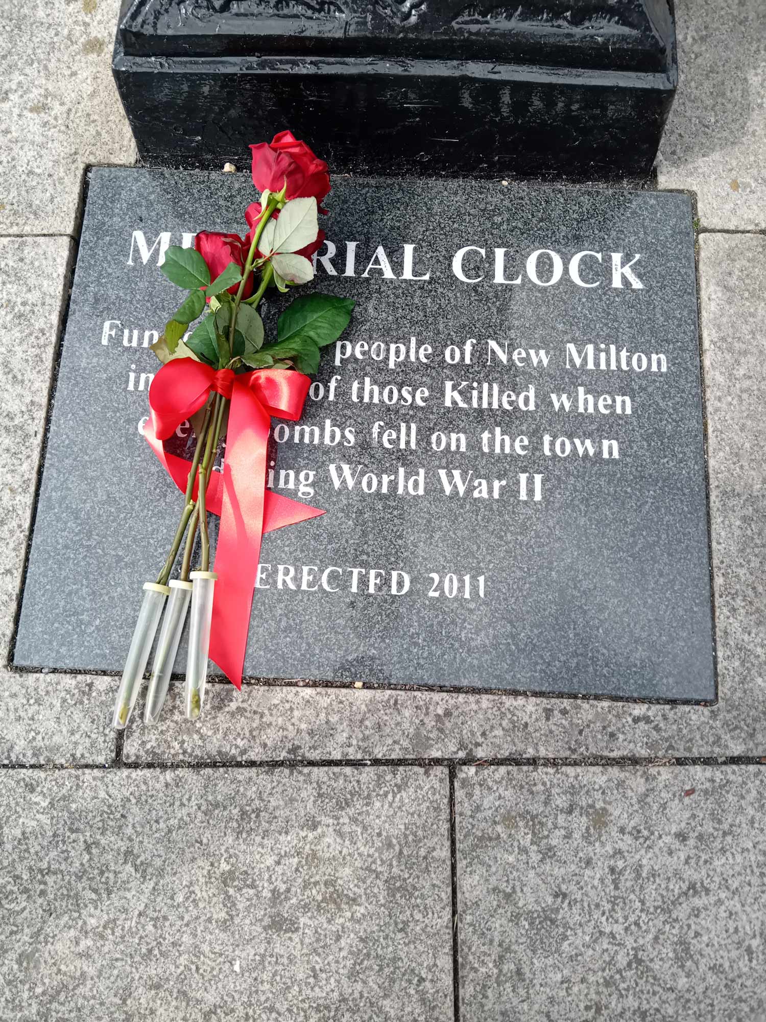 3 red roses at the memorial clock