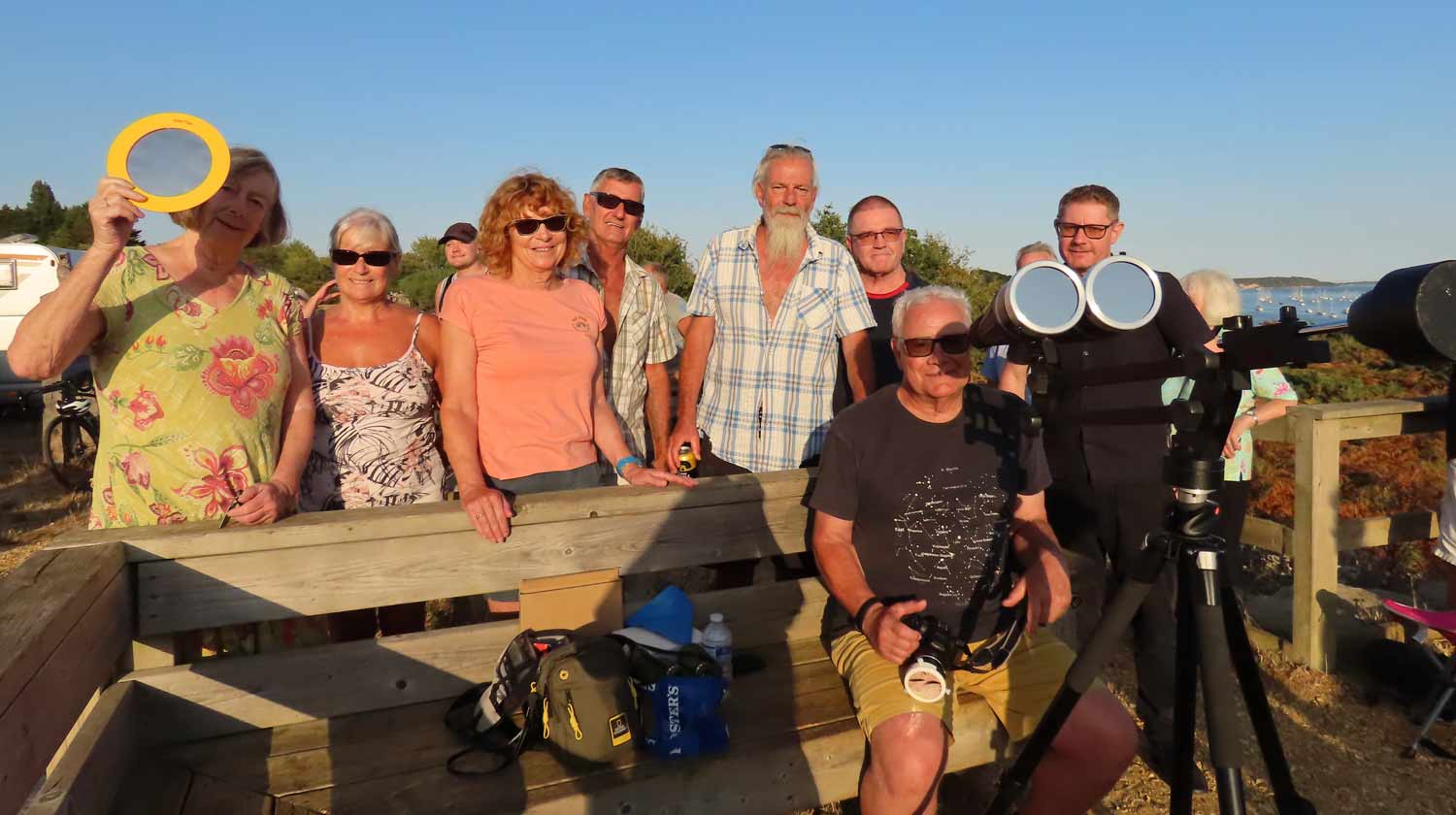 Tim Guppy (seated) shares his specialist viewing equipment with eclipse hunters