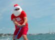 Santa surfing on holiday